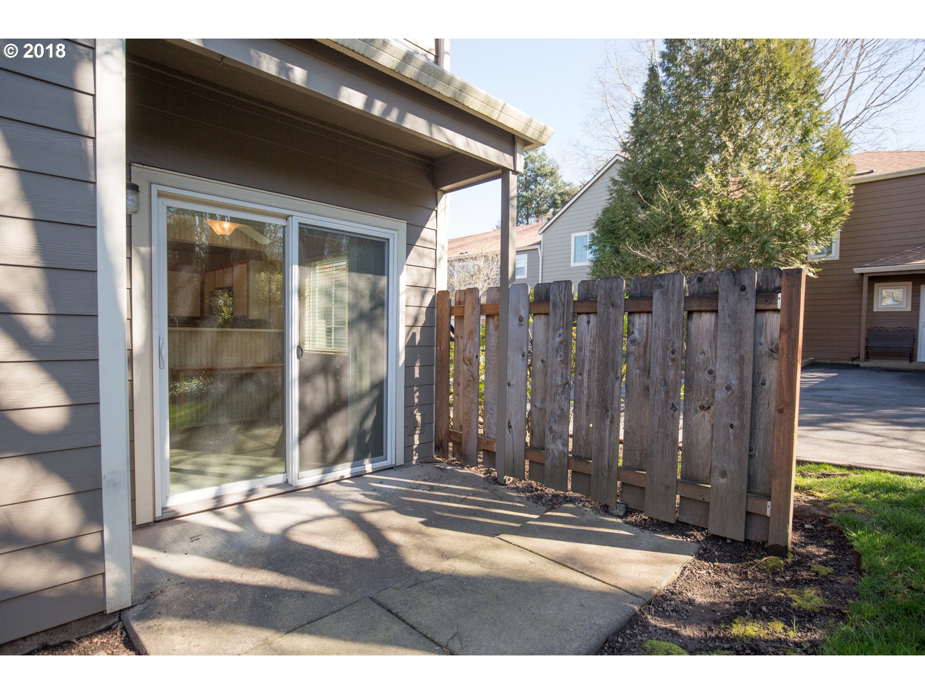 7123 Southwest Sagert Street, Unit 101 Tualatin, OR 97062 - Photo 16 of 24 a view of a house with a wooden fence