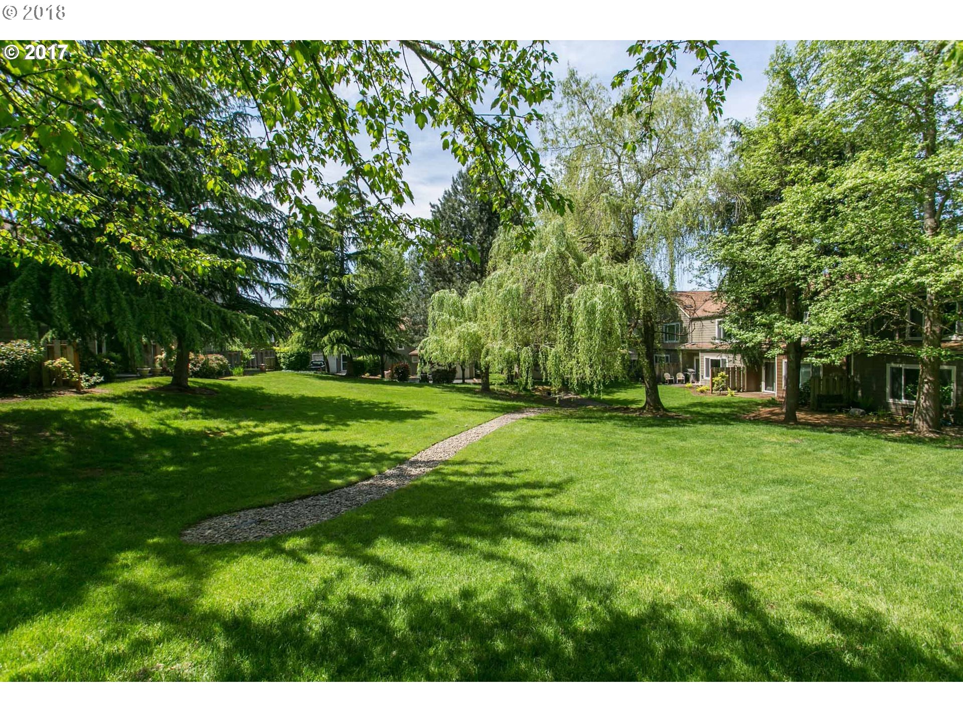 7123 Southwest Sagert Street, Unit 101 Tualatin, OR 97062 - Photo 17 of 24 a view of a park with large trees