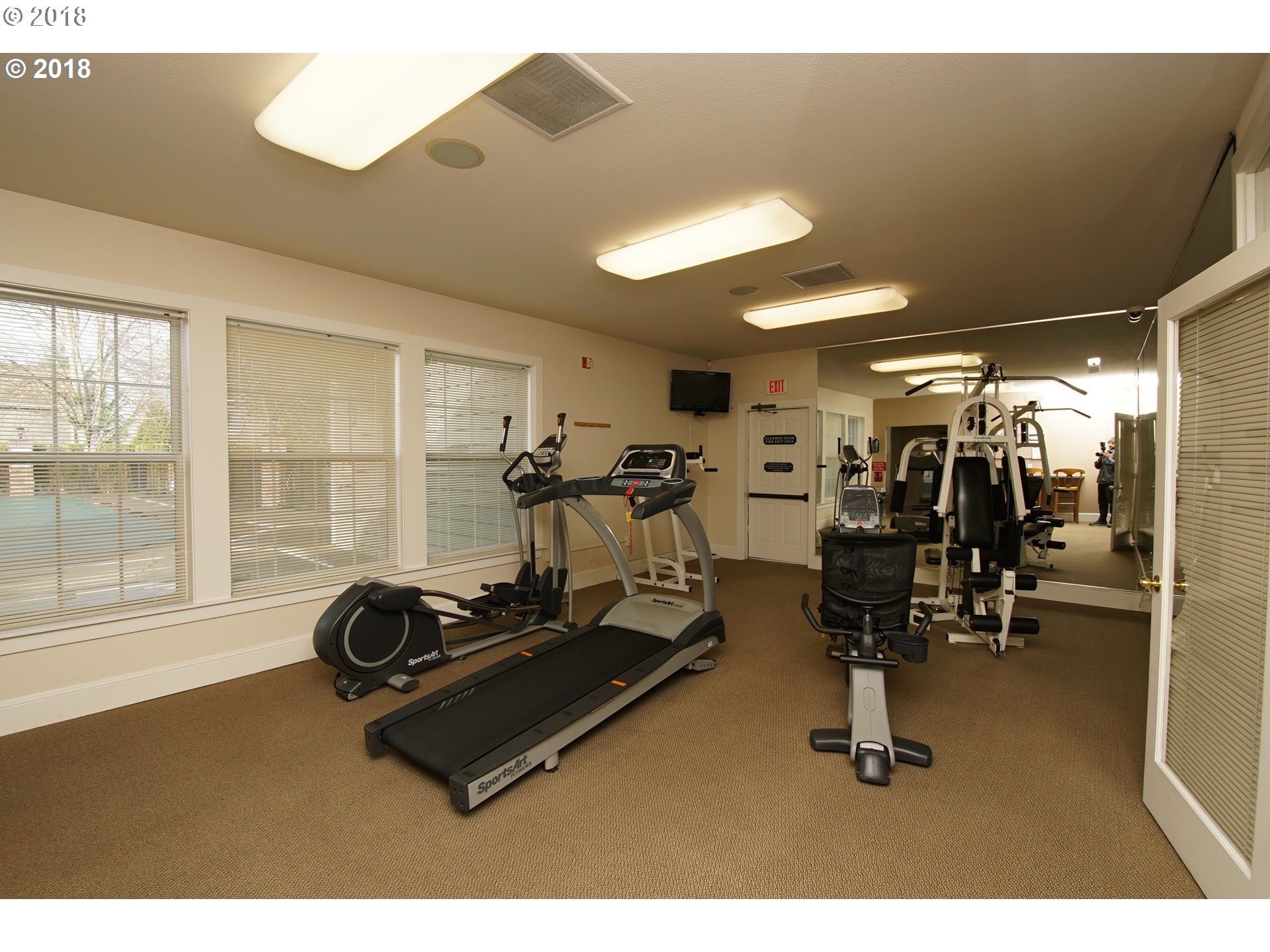 7123 Southwest Sagert Street, Unit 101 Tualatin, OR 97062 - Photo 19 of 24 a room with gym equipment and large mirror