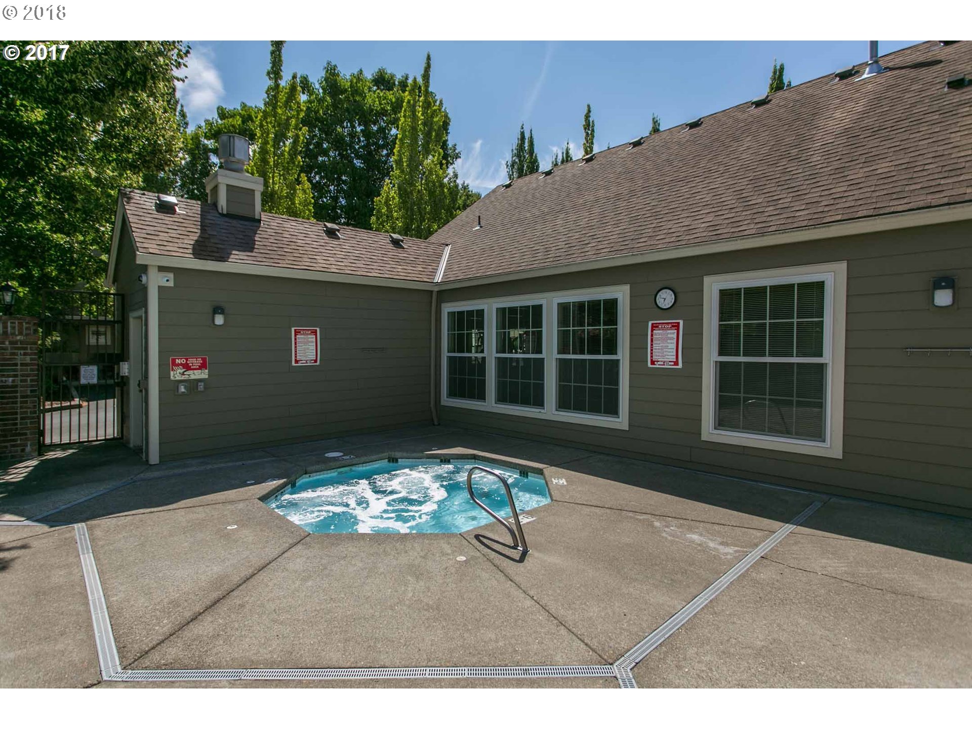 7123 Southwest Sagert Street, Unit 101 Tualatin, OR 97062 - Photo 21 of 24 a front view of a house with a yard