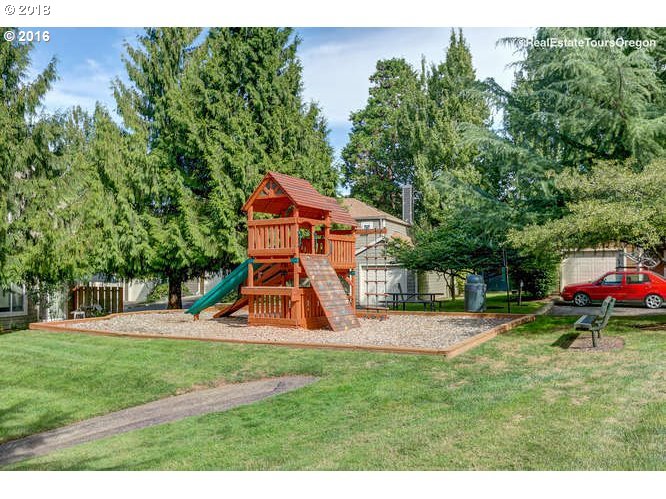 7123 Southwest Sagert Street, Unit 101 Tualatin, OR 97062 - Photo 24 of 24 swimming pool with trees and wooden fence