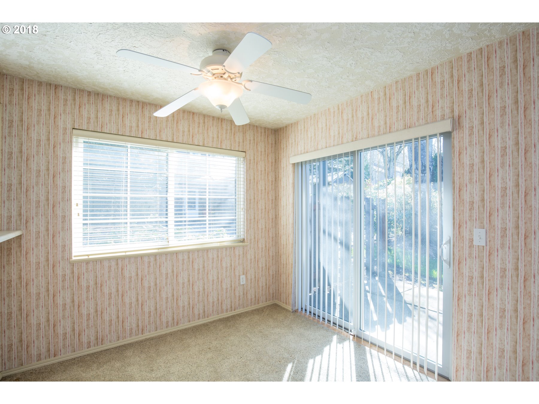 7123 Southwest Sagert Street, Unit 101 Tualatin, OR 97062 - Photo 4 of 24 a view of an empty room with a window