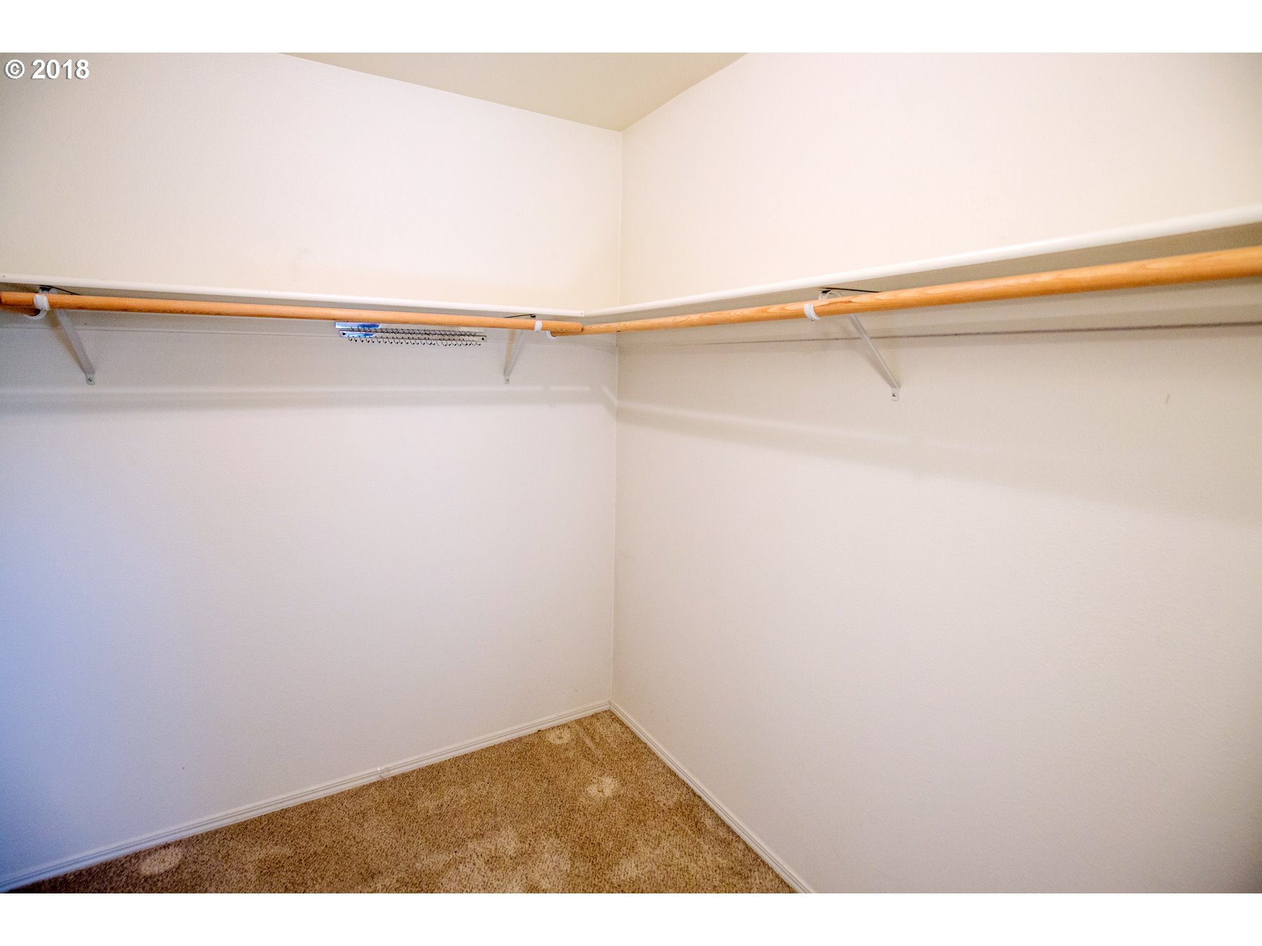 7123 Southwest Sagert Street, Unit 101 Tualatin, OR 97062 - Photo 10 of 24 a view of a room with racks on the wall