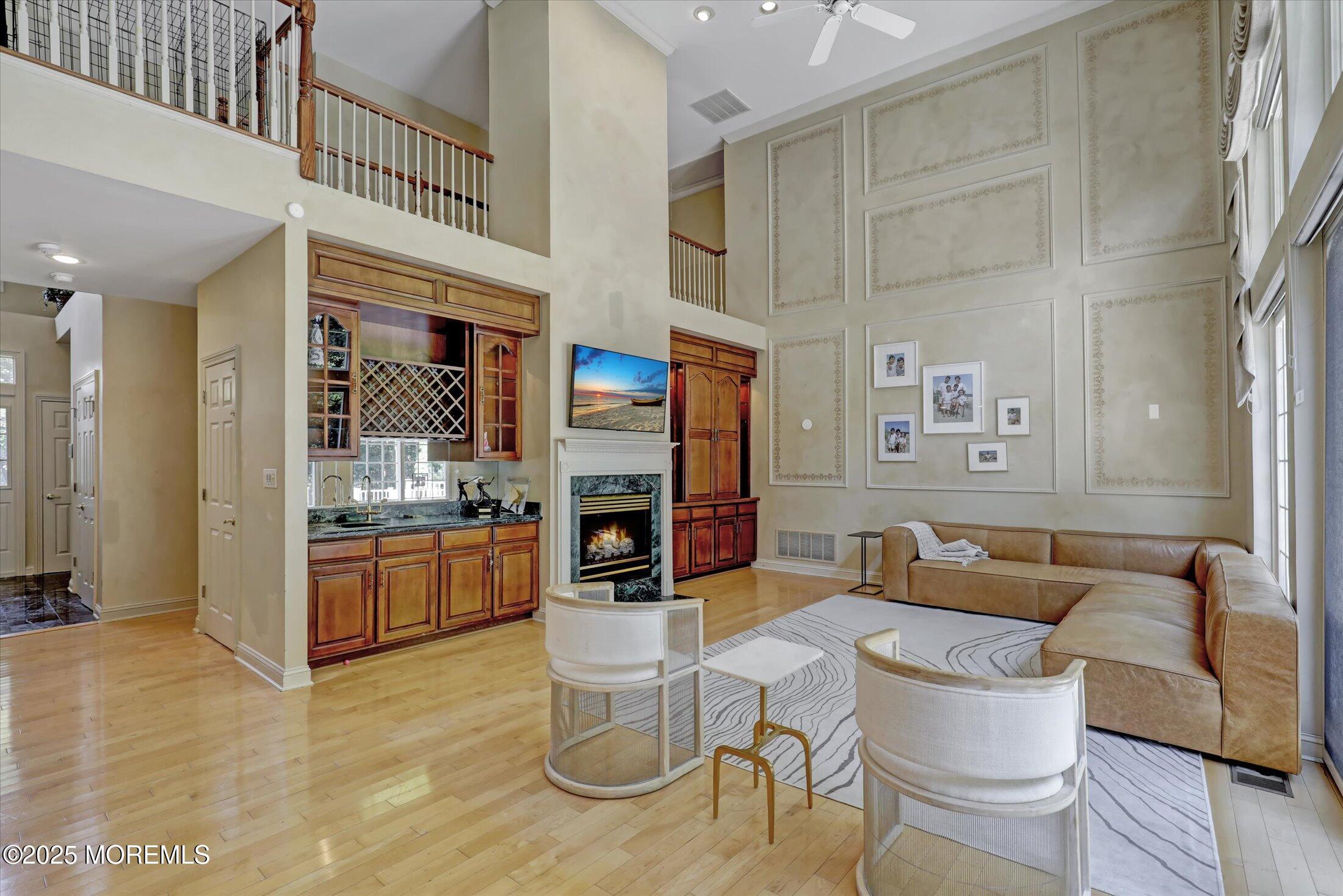 26 Bruns Road West Allenhurst, NJ 07711 - Photo 13 of 66 a living room with fireplace furniture and a kitchen view