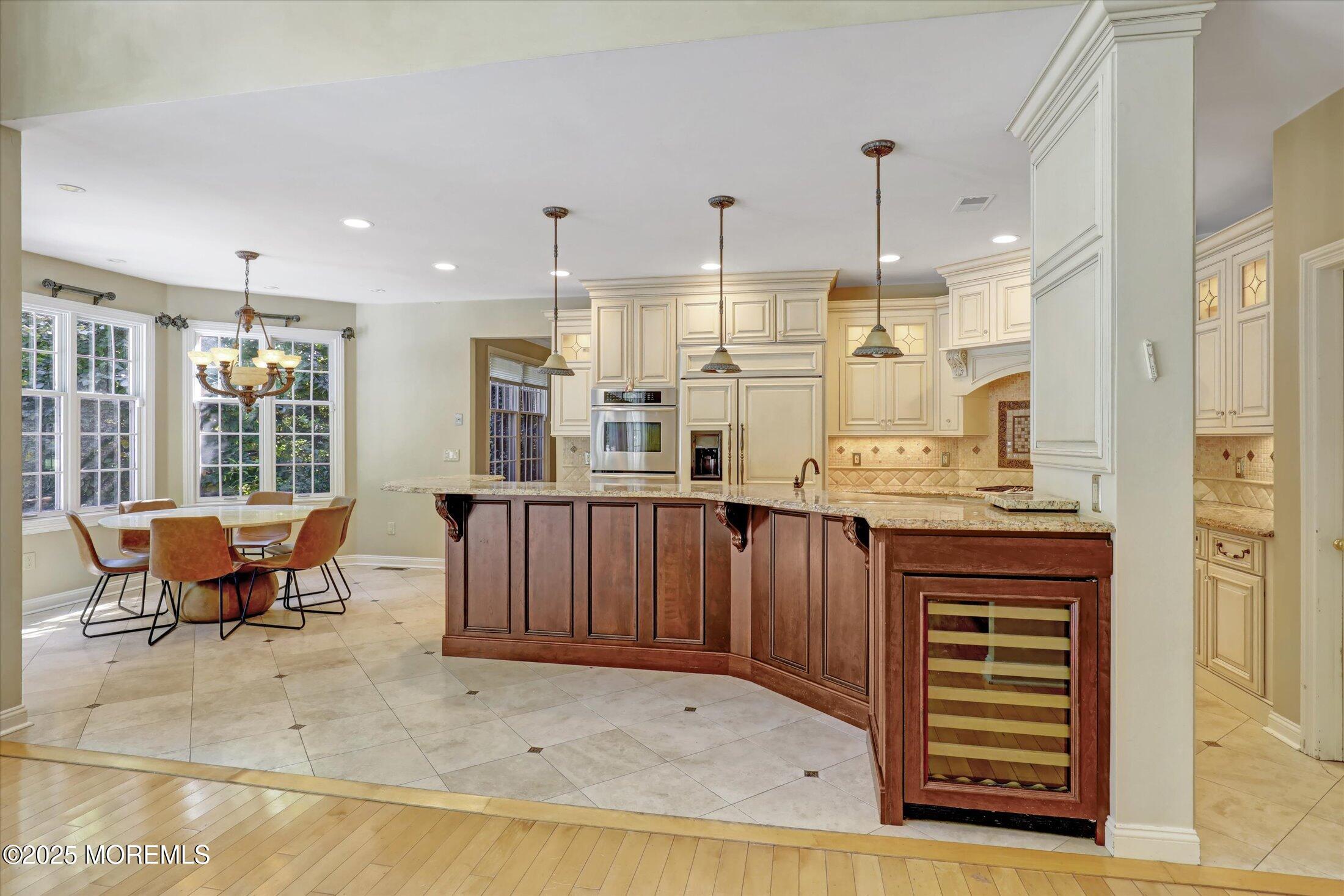 26 Bruns Road West Allenhurst, NJ 07711 - Photo 15 of 66 a open kitchen with stainless steel appliances granite countertop a stove a sink dishwasher and a refrigerator with wooden floor
