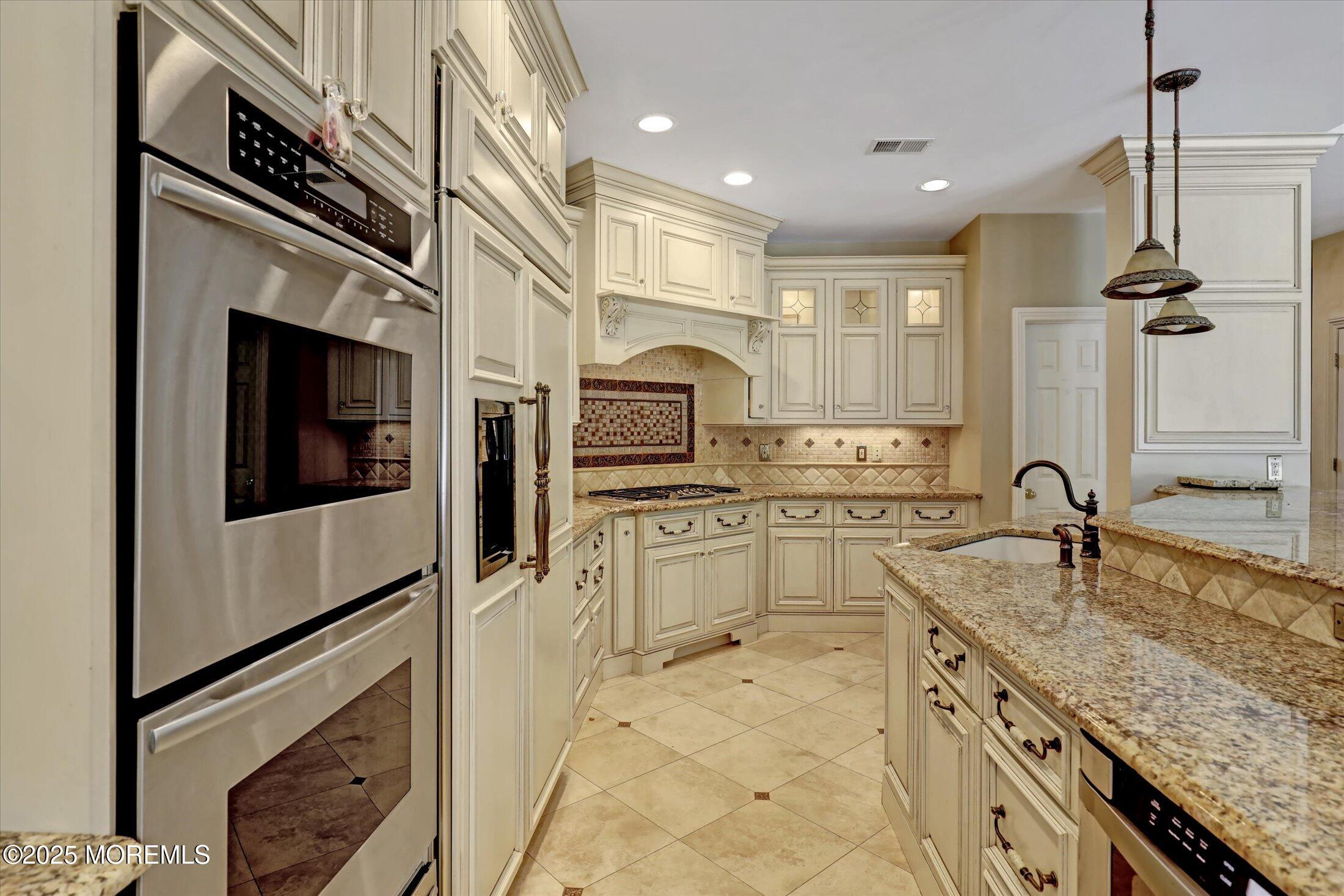 26 Bruns Road West Allenhurst, NJ 07711 - Photo 19 of 66 a kitchen with stainless steel appliances granite countertop a sink and dishwasher a stove top oven with wooden floor