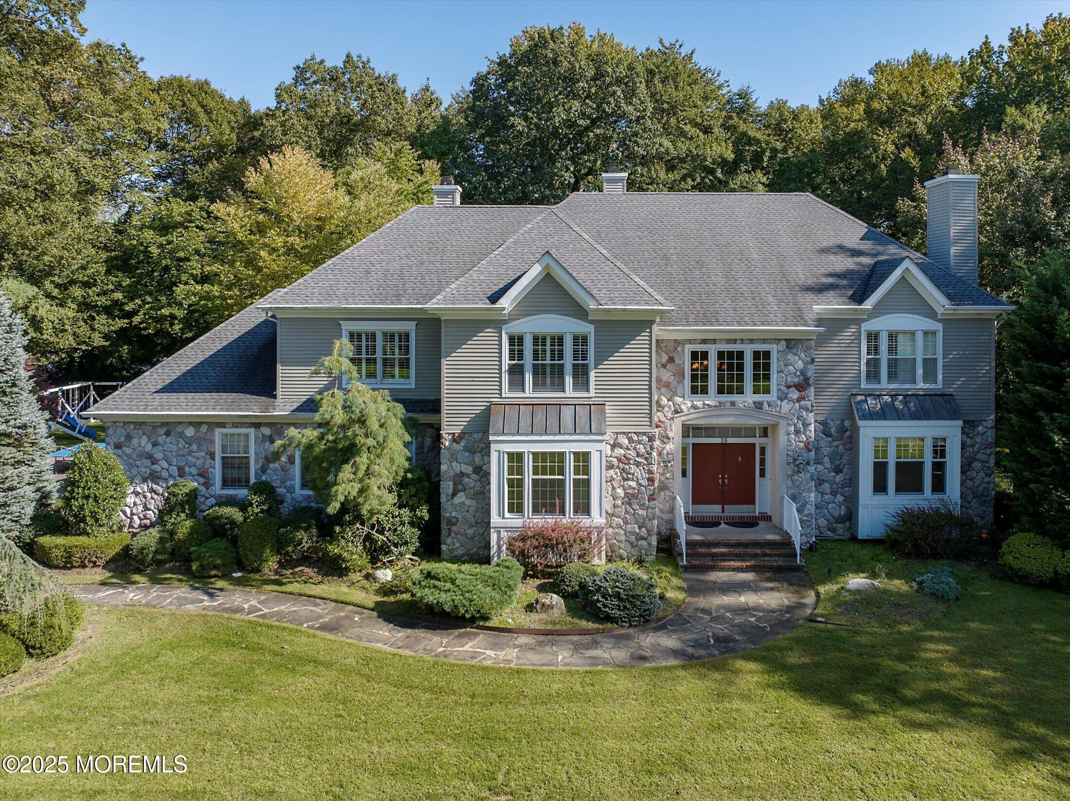 26 Bruns Road West Allenhurst, NJ 07711 - Photo 2 of 66 a front view of a house with a garden and plants