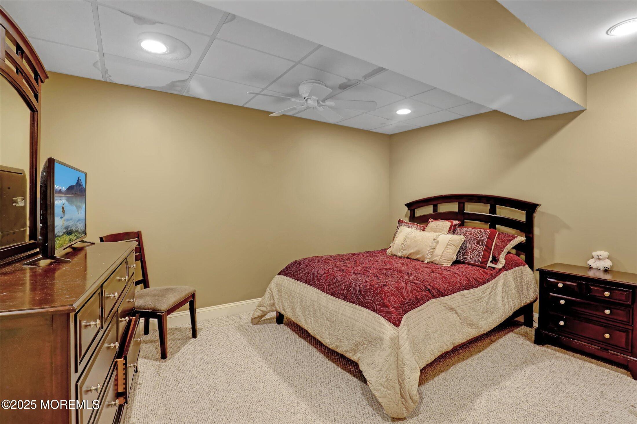 26 Bruns Road West Allenhurst, NJ 07711 - Photo 48 of 66 a bedroom with a bed and a tv on the dresser
