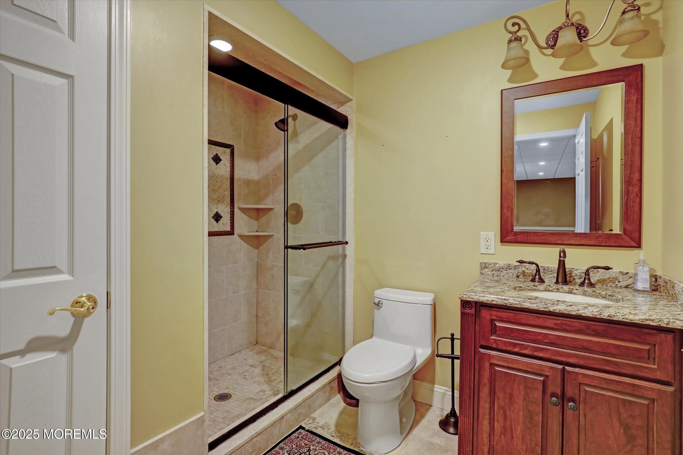 26 Bruns Road West Allenhurst, NJ 07711 - Photo 49 of 66 a bathroom with a toilet sink vanity and mirror