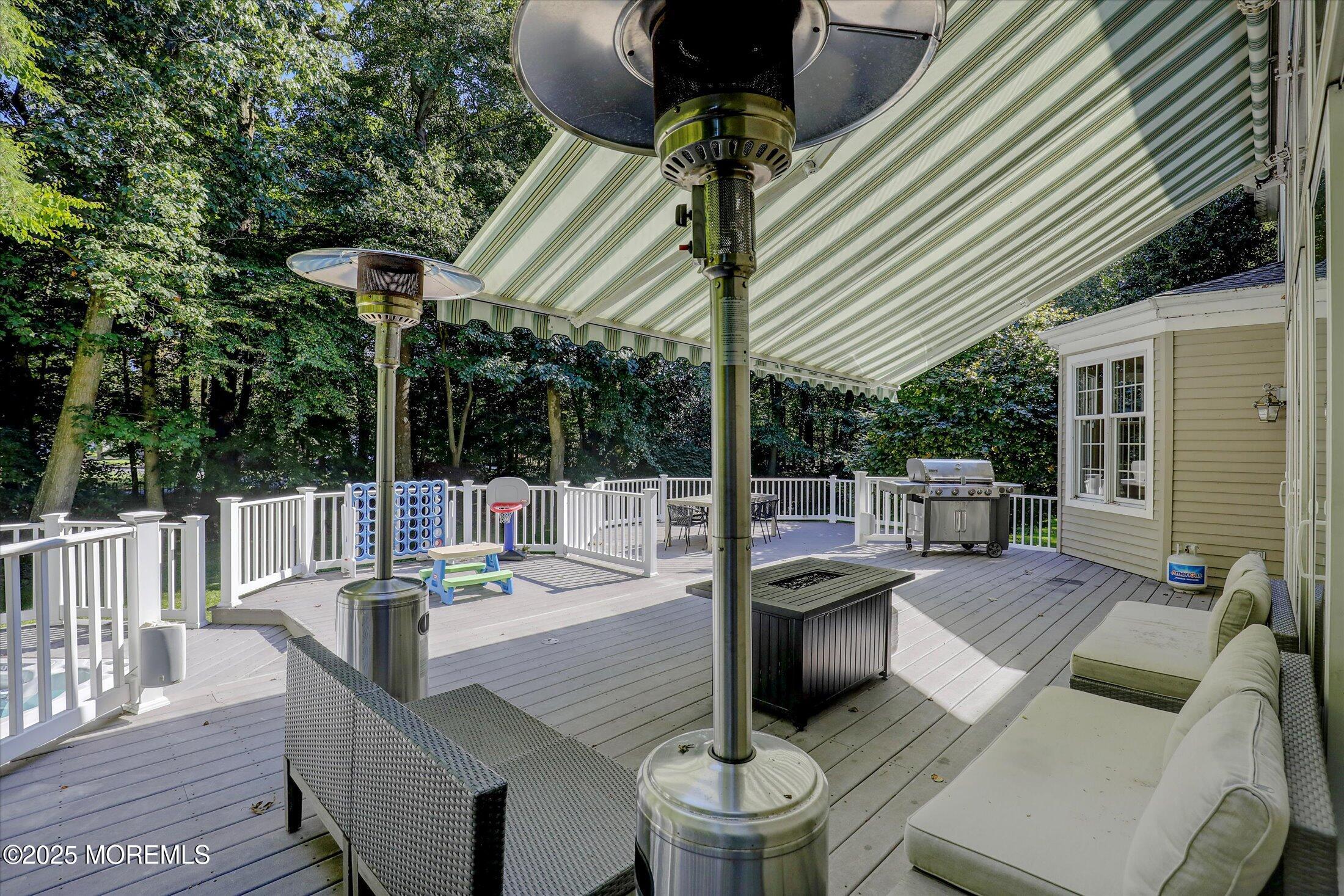 26 Bruns Road West Allenhurst, NJ 07711 - Photo 54 of 66 a view of a patio with couches table and chairs and wooden fence