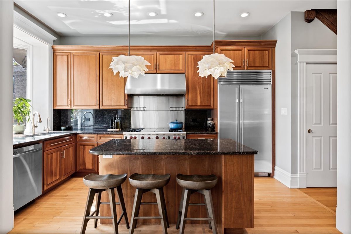 2845 West Division Street Chicago, IL 60622 - Photo 13 of 49 a kitchen with stainless steel appliances granite countertop a stove a sink and a refrigerator