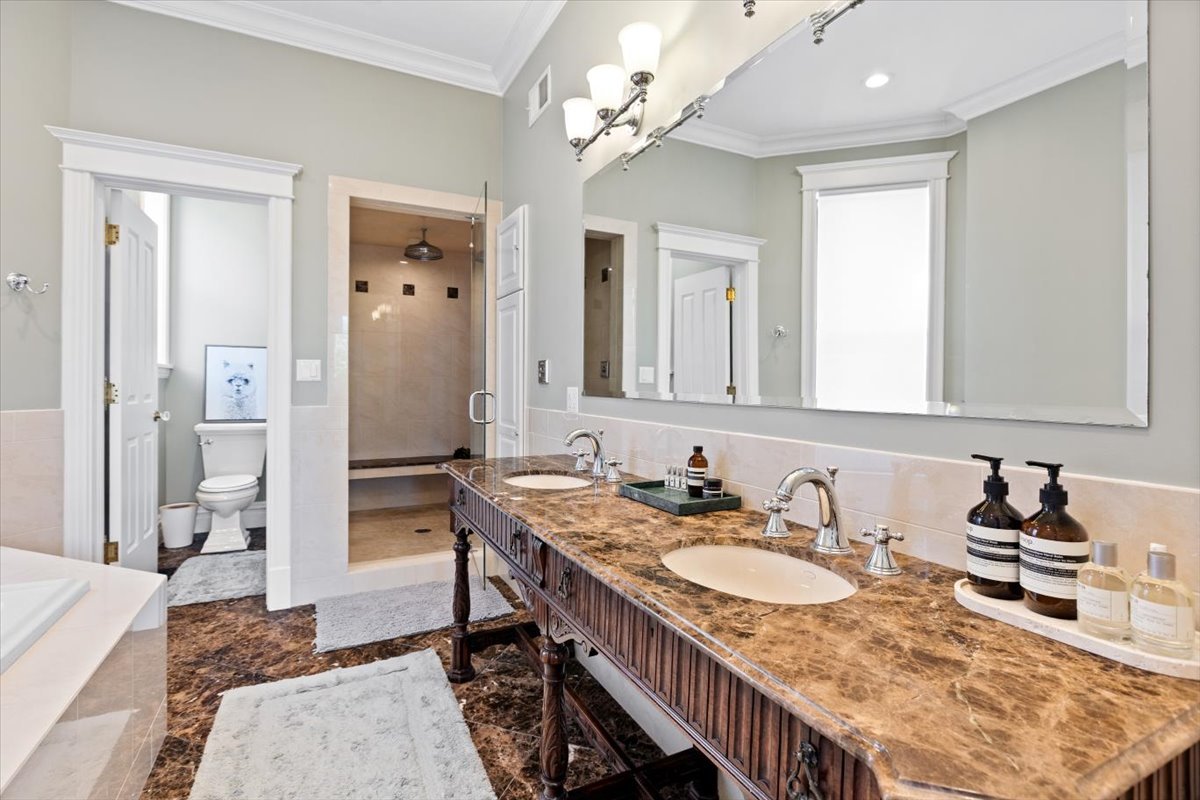 2845 West Division Street Chicago, IL 60622 - Photo 25 of 49 a en suite bathroom with sinks granite countertop tub and a mirror
