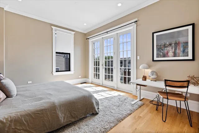 a bedroom with a bed and a large window