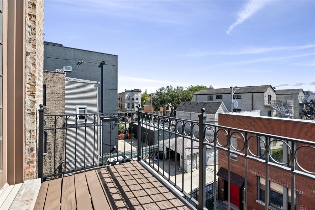 2845 West Division Street Chicago, IL 60622 - Photo 29 of 49 a view of a balcony with wooden floor and city view