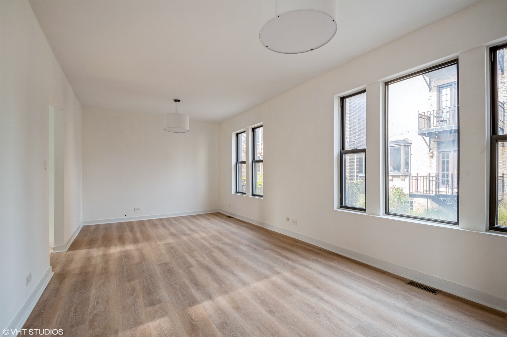 2845 West Division Street Chicago, IL 60622 - Photo 45 of 49 a view of an empty room with wooden floor and a window