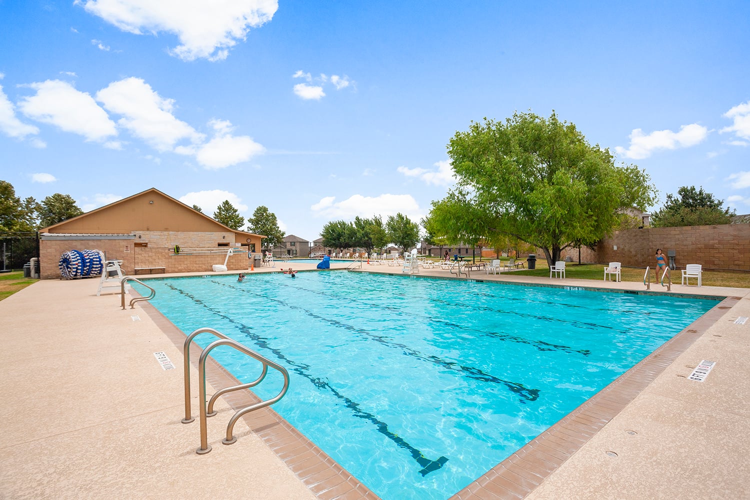 252 Firefox Way Jarrell, TX 76537 - Photo 4 of 11 An inviting outdoor community pool offers refreshing leisure under clear skies, perfect for summer days.