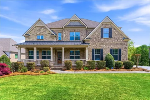 a front view of a house with yard and green space