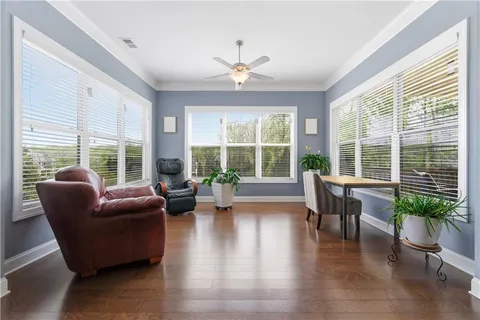 a living room with fireplace furniture and a large window