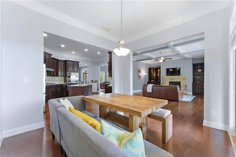 a large kitchen with stainless steel appliances wooden cabinets a stove top oven a sink and dishwasher