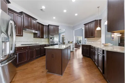 a kitchen with stainless steel appliances granite countertop a stove and a sink