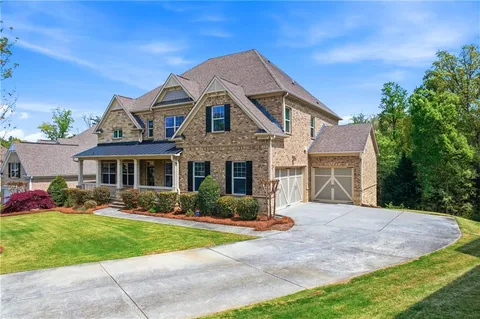 a front view of a house with a yard and garage