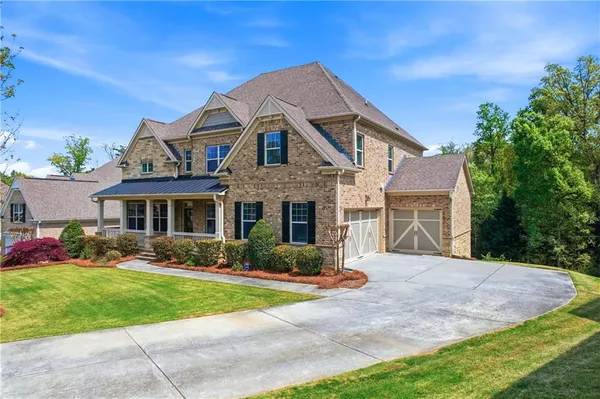 a front view of a house with a yard and garage