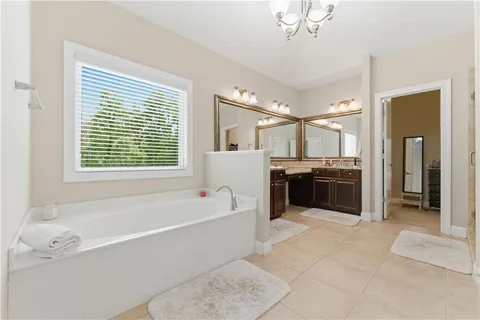a bathroom with a granite countertop sink a toilet and a mirror