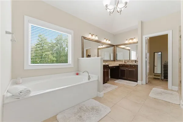 a bathroom with a granite countertop sink a toilet and a mirror