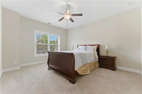 a bedroom with a bed gym equipment and a window