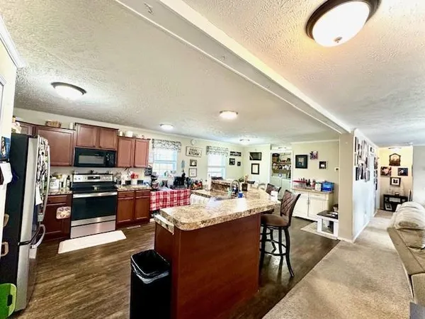 a view of a dining room kitchen with furniture and wooden floor