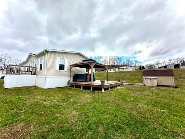 a view of a house with a yard and sitting area