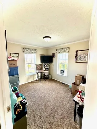a view of a livingroom with furniture and a window