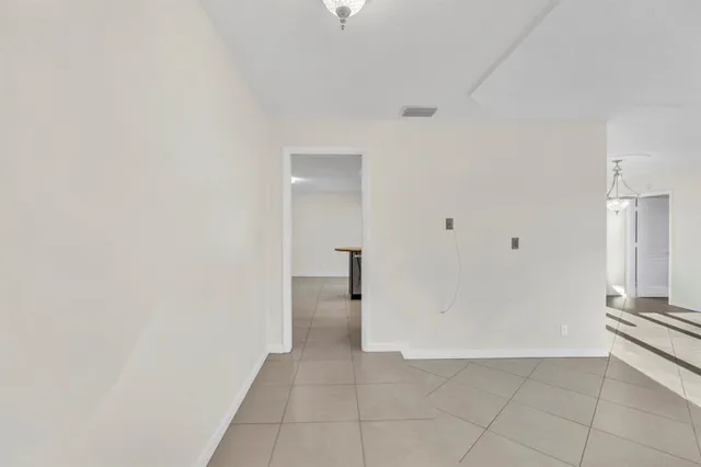 a kitchen with a sink and a stove top oven with wooden floor
