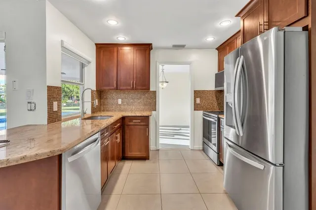 a kitchen with stainless steel appliances granite countertop a stove and a refrigerator