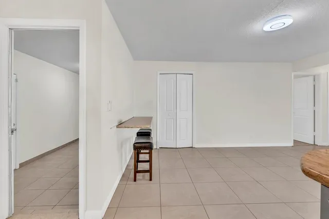 a view of a hallway with wooden floor and closet