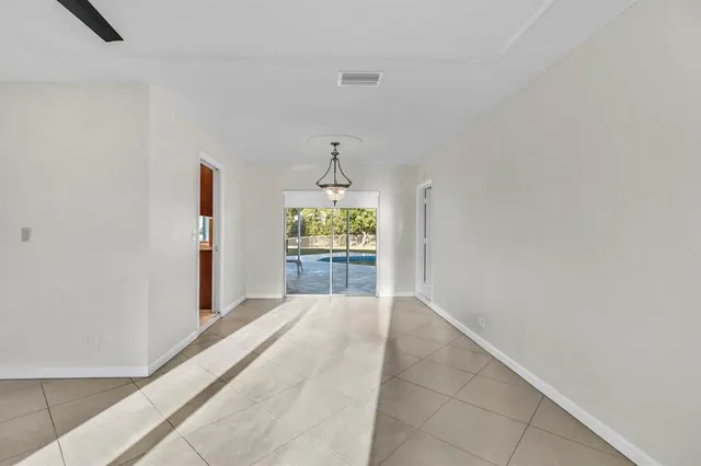 a view of kitchen with furniture and refrigerator
