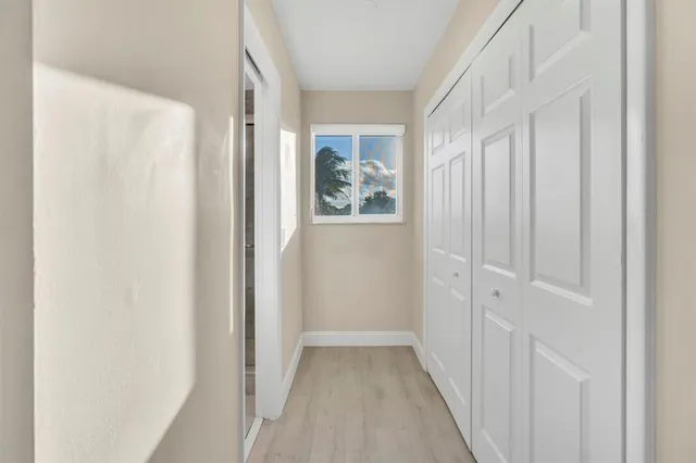 a view of a big room with wooden floor and windows