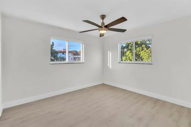 a view of a porch with a table and chairs