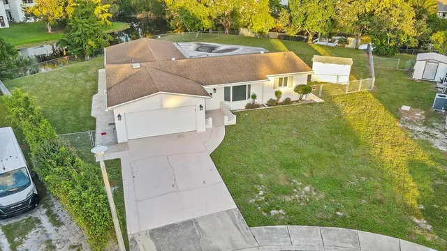 a front view of a house with a garden and trees