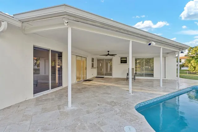 an aerial view of a house with a swimming pool yard and outdoor seating