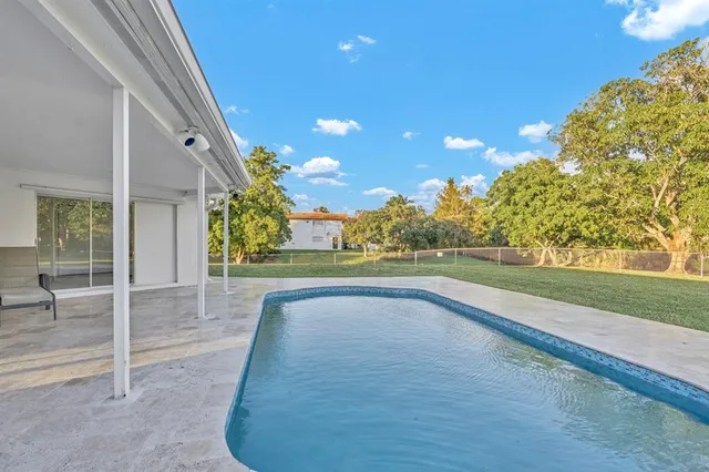 an aerial view of a house with a swimming pool