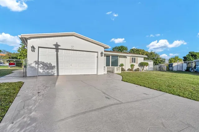 a view of a hallway with wooden floor and a potted plant