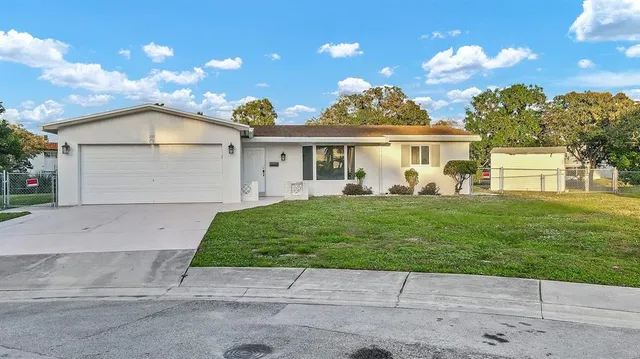 a view of a house with backyard and sitting area