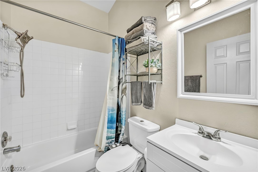 1234 Sunfire Street Henderson, NV 89014 - Photo 16 of 40 A well-appointed bathroom with a pristine tub and shower, a classic vanity, and practical storage solutions.
