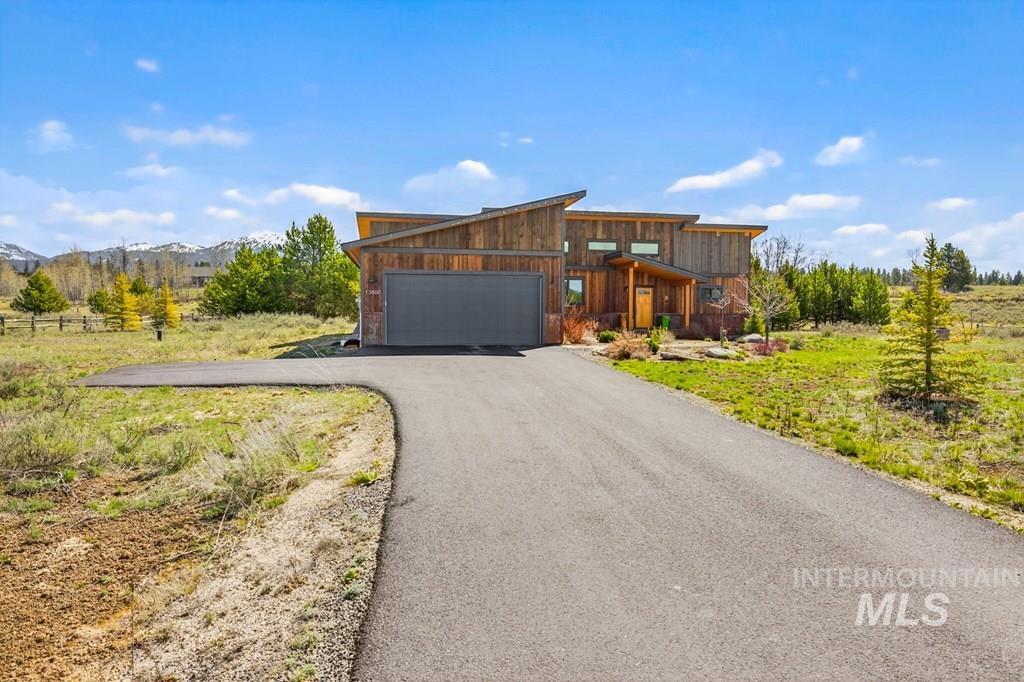 13800 Raptor Loop McCall, ID 83638 - Photo 23 of 34 Modern architectural design featuring extensive wood paneling and a dark-toned garage door