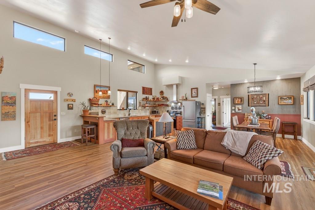 13800 Raptor Loop McCall, ID 83638 - Photo 4 of 34 High ceilings featuring clerestory windows, wood-finish flooring, a natural wood entry door, and recessed lighting