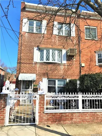 a front view of a building with a yard