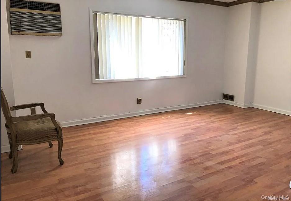 1574 Paulding Avenue, Unit 2 Bronx, NY 10462 - Photo 16 of 25 a view of an empty room with wooden floor and a window