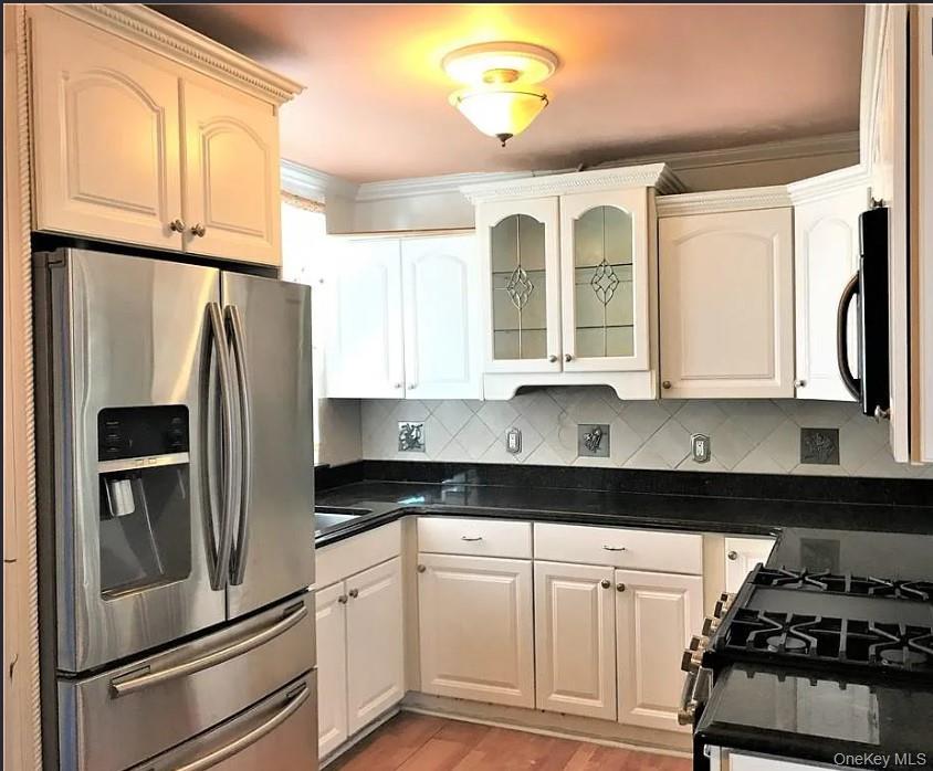 1574 Paulding Avenue, Unit 2 Bronx, NY 10462 - Photo 19 of 25 a kitchen with granite countertop a refrigerator sink and stove