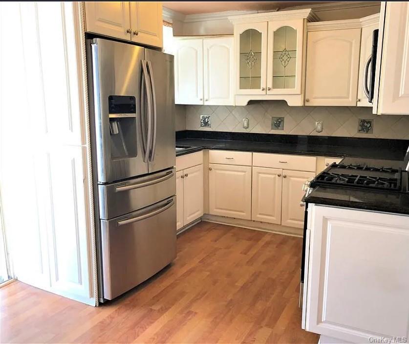 1574 Paulding Avenue, Unit 2 Bronx, NY 10462 - Photo 20 of 25 a kitchen with stainless steel appliances granite countertop a refrigerator sink and stove